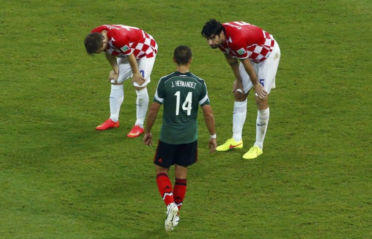 Croatia's Modric and Corluka React Near Mexico's Hernandez After Their 2014 World Cup Group A Soccer Match in Recife