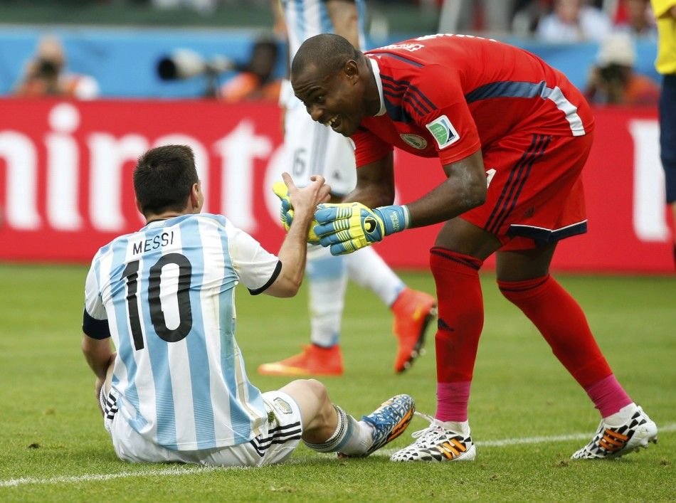 Nigerias goalkeeper Vincent Enyeama R helps Argentinas Lionel Messi up 