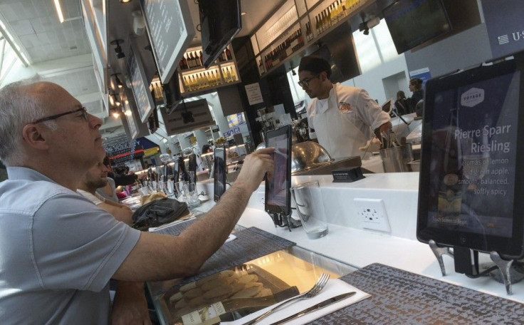 A  passenger uses an iPad to order food in a Delta terminal in LaGuardia Airport in New York 