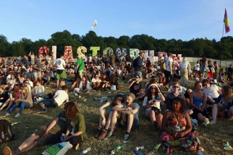 Festival goers relax at Worthy Farm in Somerset as the sun sets on the first day of the Glastonbury music festival June 25, 2014. Picture taken June 25, 2014.