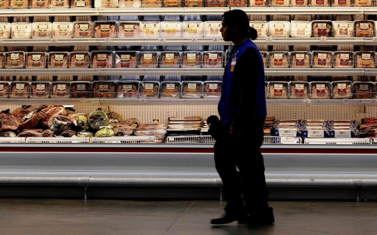 A employee walks by a meat cooler in the grocery section of a Sam's Club during a media tour in Bentonville, Arkansas June 5, 2014. 