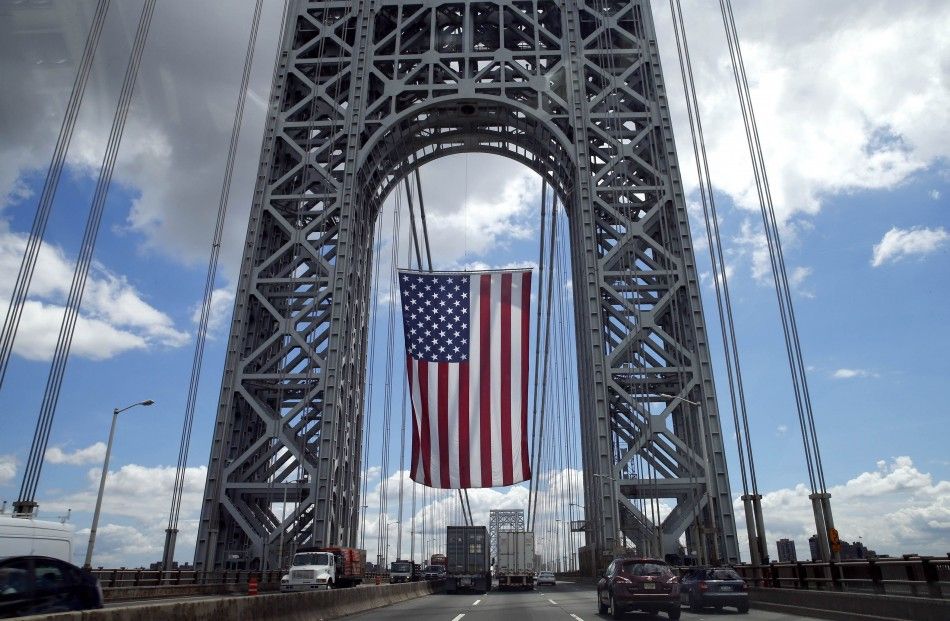 A giant American flag hangs from the West tower of the George Washington Bridge