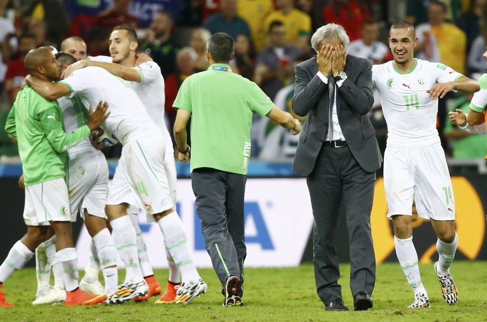 Algerias coach Vahid Halilhodzic reacts as he and his players celebrate 