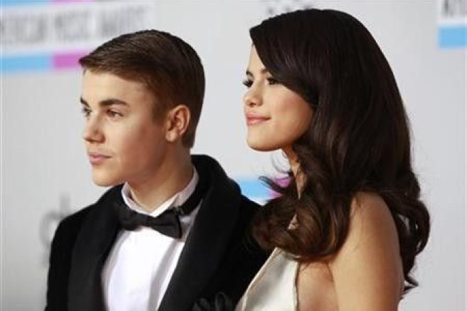 Selena Gomez and Justin Bieber pose on arrival at the 2011 American Music Awards in Los Angeles