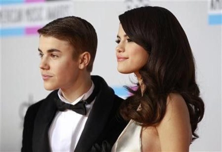 Selena Gomez and Justin Bieber pose on arrival at the 2011 American Music Awards in Los Angeles
