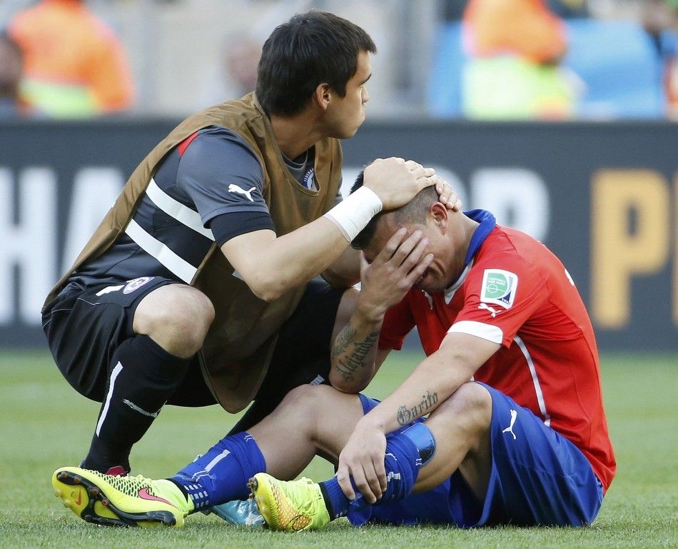 Chiles Gary Medel R is comforted by goalkeeper Johnny Herrera