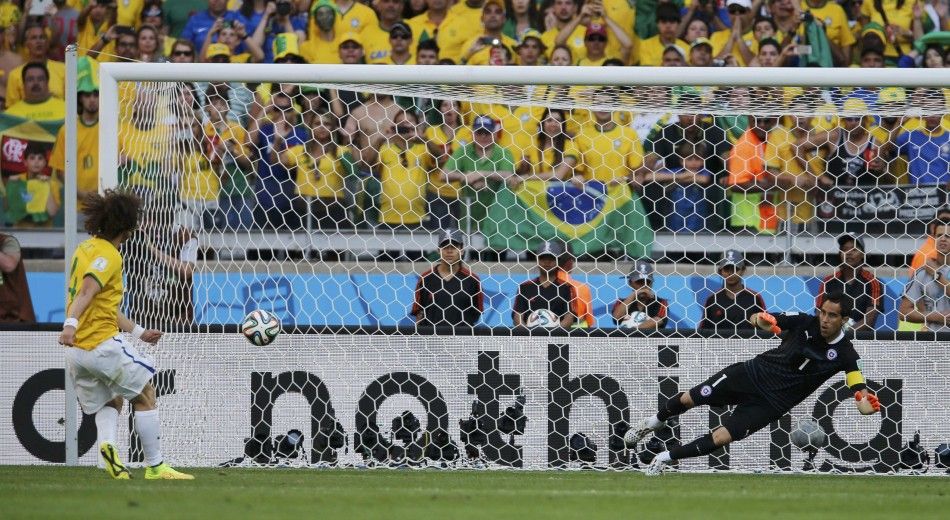 Brazils David Luiz L scores his penalty past Chiles Claudio Bravo