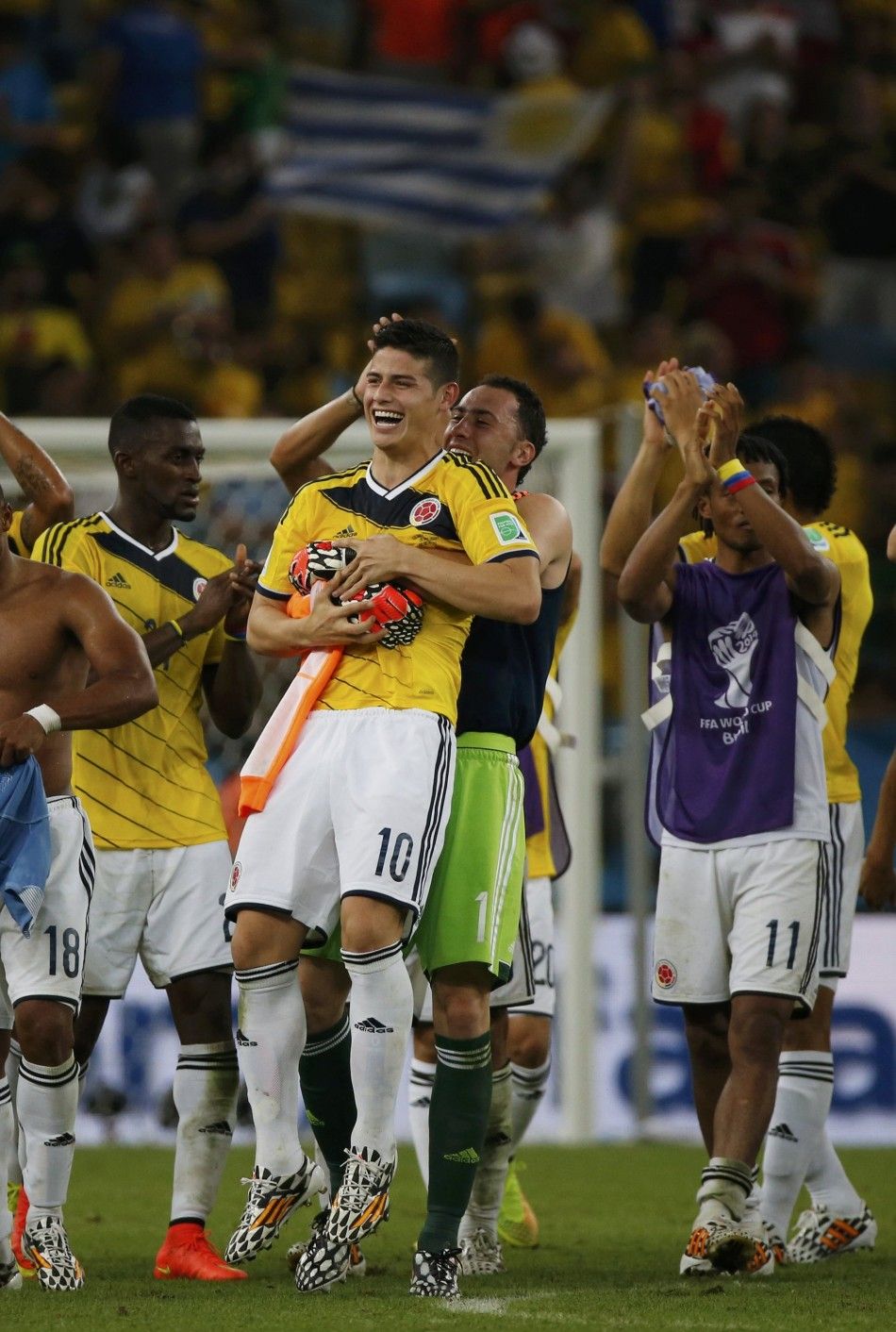 Colombias James Rodriguez C is hugged by teammate David Ospina 