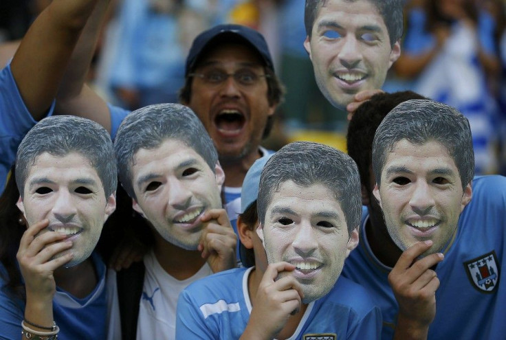 Fans of Uruguay pose with masks of Suarez before their 2014 World Cup round of 16 game against Colombia at the Maracana in Rio de Janeiro