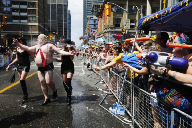 A man dressed to mock Toronto Mayor Rob Ford gets sprayed by water guns at the&quot; WorldPride&quot; gay pride Parade in Toronto