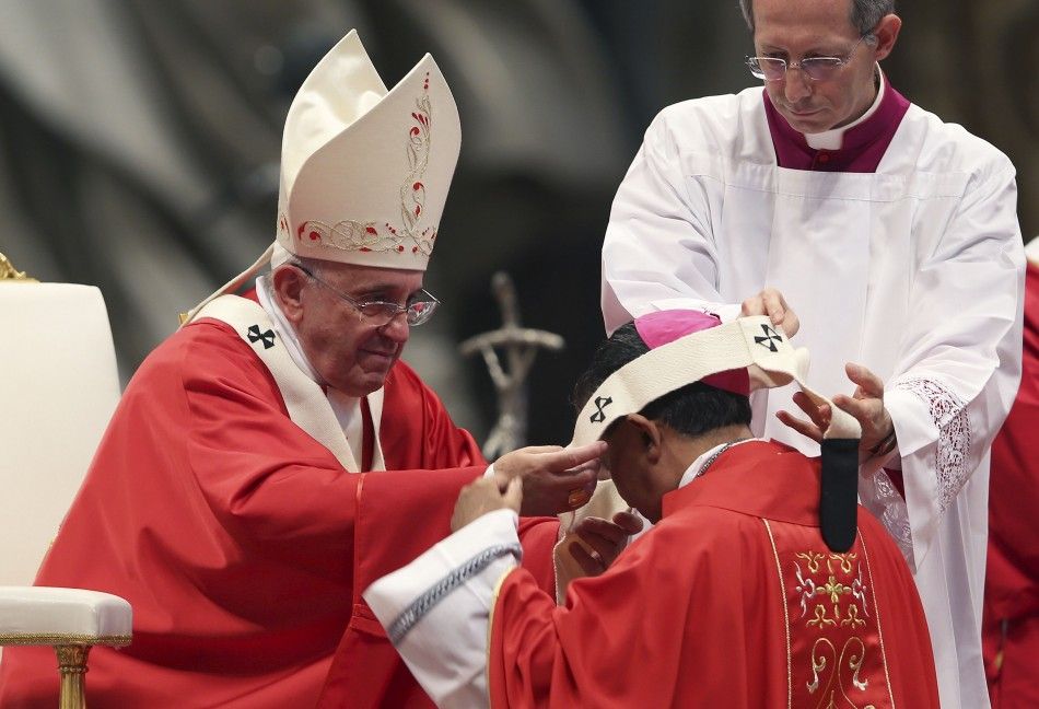 Pope Francis presents Indonesian Archbishop Agustinus Ague C with his pallium in Saint Peters Basilica at the Vatican June 29, 2014. REUTERSAlessandro Bianchi VATICAN - Tags RELIGION