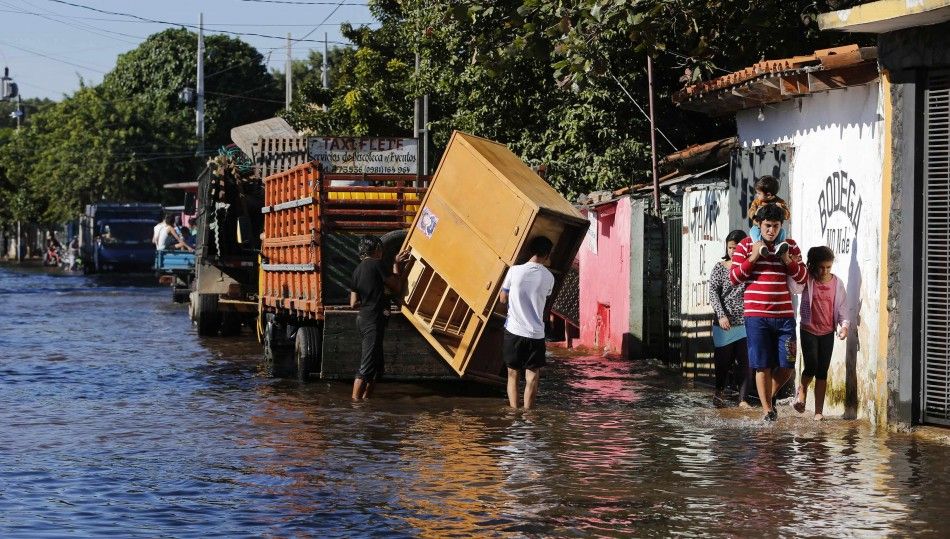 Paraguayans remove their belongings from their flooded houses near the Paraguay river in Asuncion, June 9, 2014. The National Emergency Secretary estimates that about 20,000 families are affected by the flooding of the countrys two main rivers, the Parag