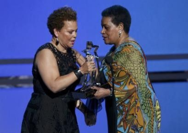 BET CEO Debra Lee (L) presents the humanitarian award, marking the 50th anniversary of the Civil Rights Act, to Mrs Myrlie Evers-Williams, on behalf of all who worked for civil rights, during the 2014 BET Awards in Los Angeles, California June 29, 2014.