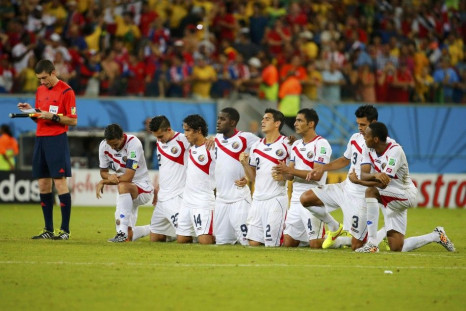 Costa Rica's players watch the penalty shootout 