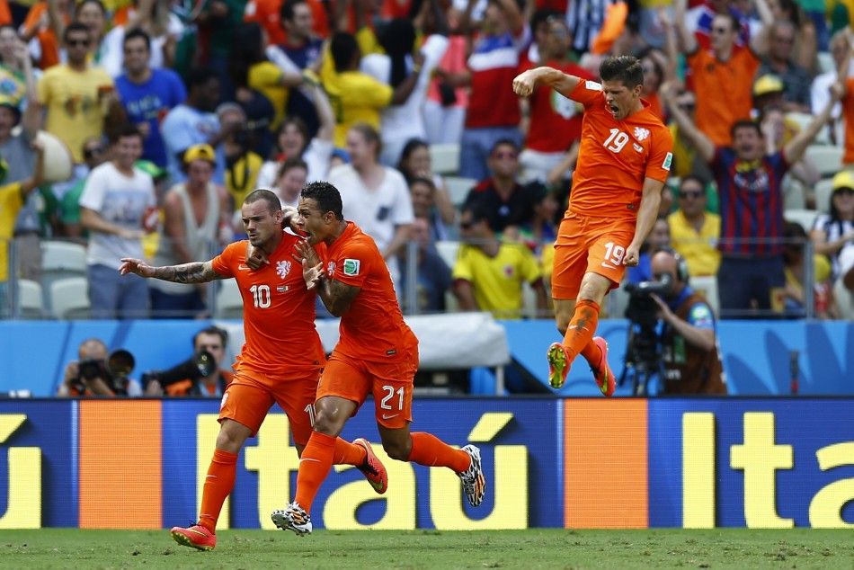 Wesley Sneijder L of the Netherlands celebrates with his teammates Memphis Depay and Klaas-Jan Huntelaar R 