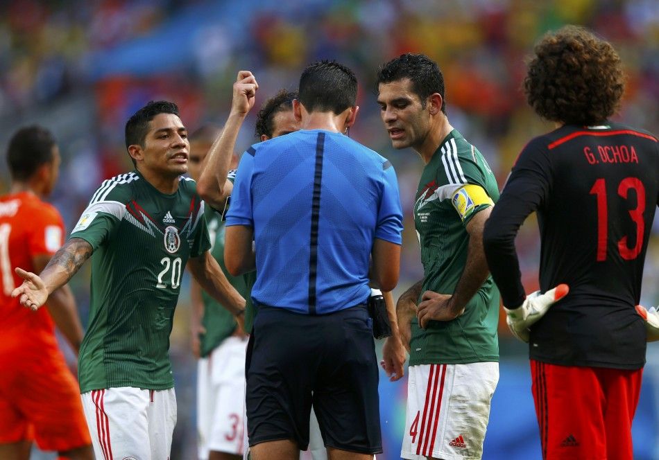 Mexicos players discuss with referee Pedro Proenca