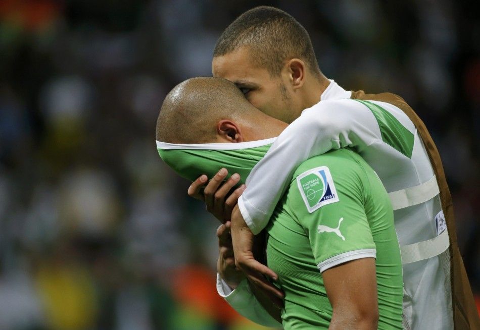 Algerias Sofiane Feghouli is consoled by teammate Djamel Mesbah 