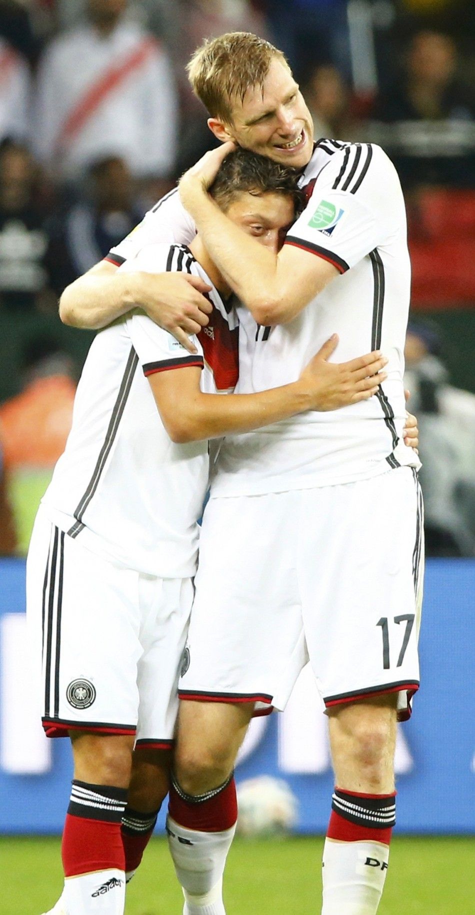 Germanys Mesut Ozil L is congratulated by teammate Per Mertesacker 