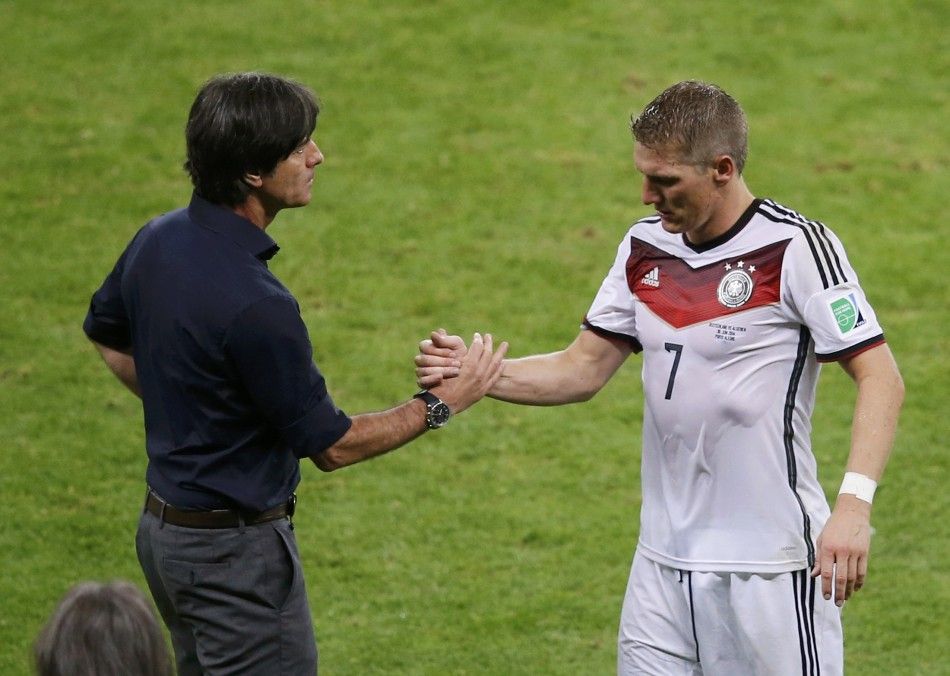 Germanys coach Joachim Loew L shakes hands with player Bastian Schweinsteiger