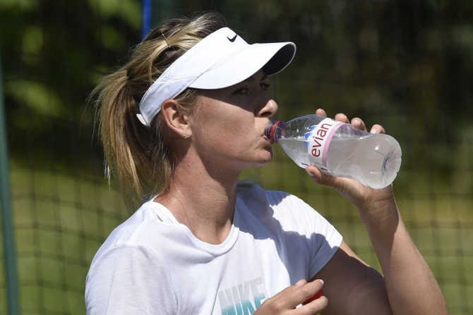 Maria Sharapova of Russia takes a drink as she practices at the Wimbledon Tennis Championships in London June 29, 2014.