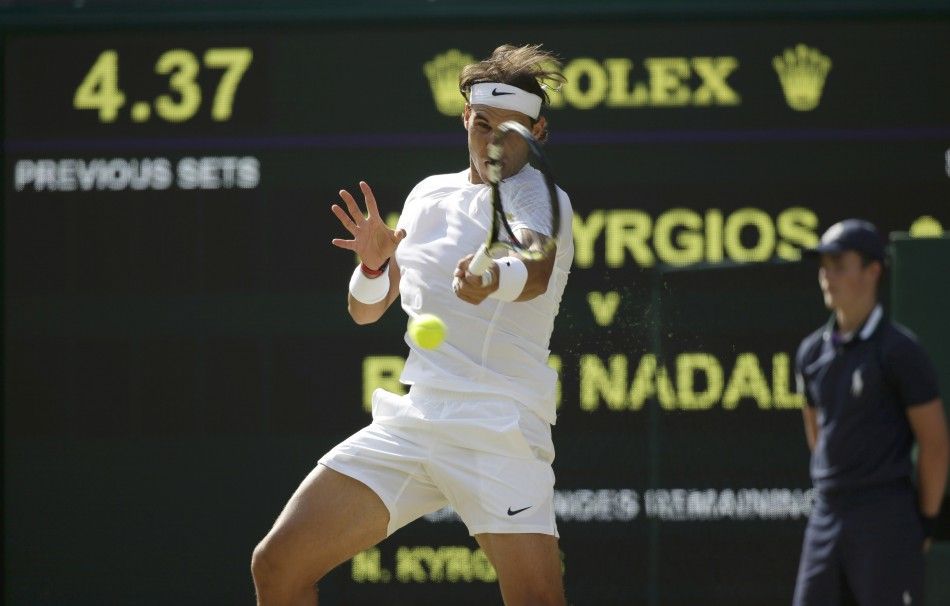 Rafael Nadal of Spain hits a return during his mens singles tennis match against Nick Kyrgios of Australia at the Wimbledon Tennis Championships, in London July 1, 2014. 