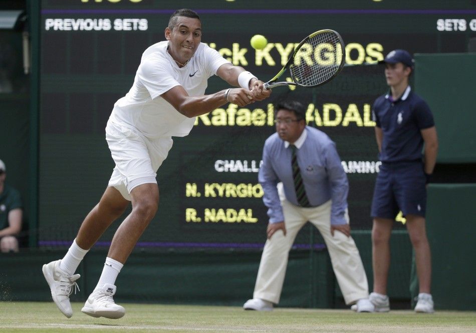 Nick Kyrgios of Australia hits a return during his mens singles tennis match against Rafael Nadal of Spain at the Wimbledon Tennis Championships, in London July 1, 2014. 