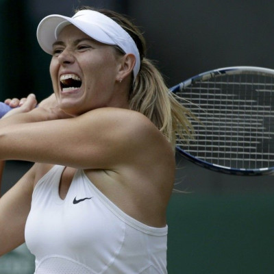 Maria Sharapova of Russia hits a return during her women's singles tennis match against Angelique Kerber of Germany at the Wimbledon Tennis Championships, in London July 1, 2014. 