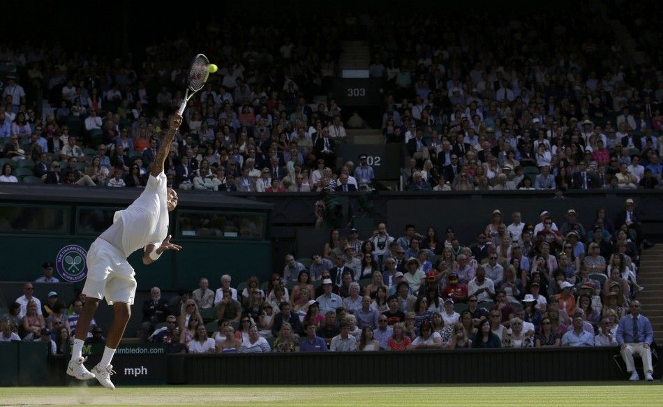 Nick Kyrgios of Australia serves during his mens singles tennis match against Rafael Nadal of Spain at the Wimbledon Tennis Championships, in London July 1, 2014. 