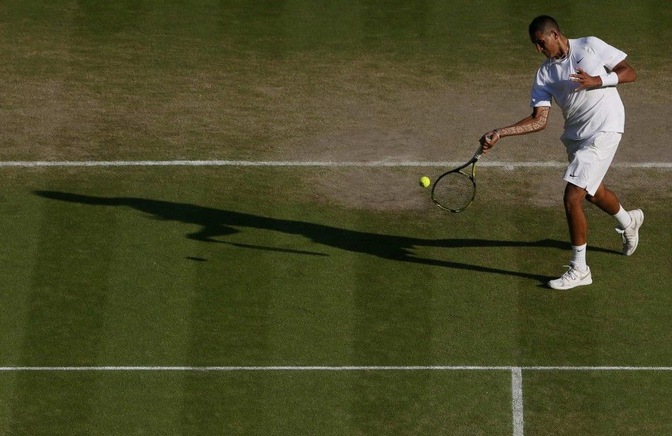 Nick Kyrgios of Australia hits a return during his mens singles tennis match against Rafael Nadal of Spain at the Wimbledon Tennis Championships, in London July 1, 2014.