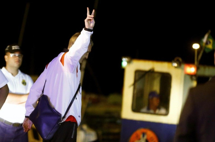 Germany&#039;s national soccer team player Schweinsteiger flashes a victory sign on his way to a ferry boat in the town of Santa Cruz Cabralia