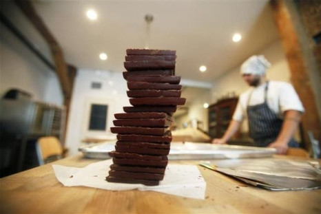 A stack of chocolate bars sits on a table before being wrapped at the Mast Brothers Chocolate factory in the Brooklyn borough of New York July 8, 2010.