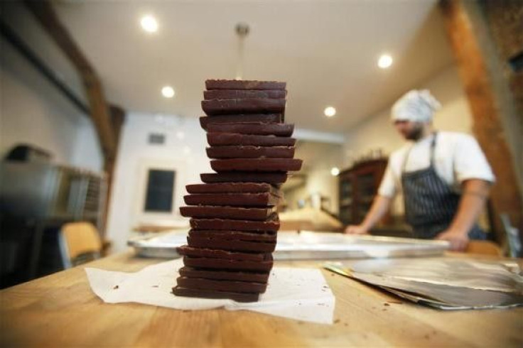 A stack of chocolate bars sits on a table before being wrapped at the Mast Brothers Chocolate factory in the Brooklyn borough of New York July 8, 2010.
