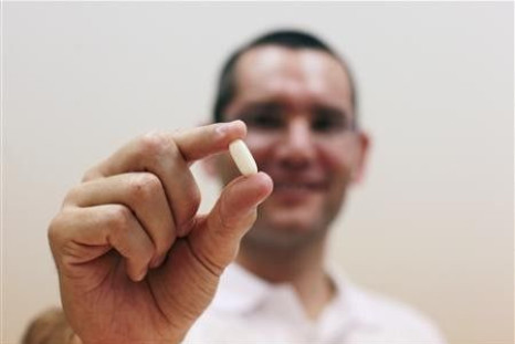 Nadav Kidron, CEO of Oramed Pharmaceuticals, shows an insulin pill as he poses for a photo at the company&#039;s offices in Jerusalem September 29, 2013.