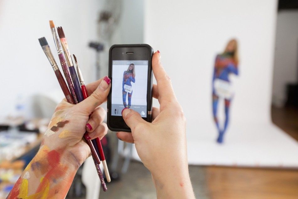 Artist Jade Little takes a photo of model Renee Somerfield 