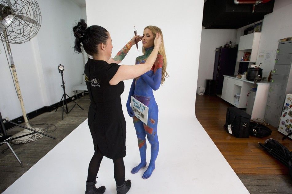 Artist Jade Little pushes hair away from model Renee Somerfields face 