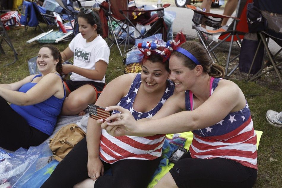 Megan ONiell and Jackie Pugsley R snap a selfie with an American flag-clad phone as officials prepare to celebrate Independence Day a day early in Boston, Massachusetts, July 3, 2014. The celebrations were moved for the first time since 1992 due to the