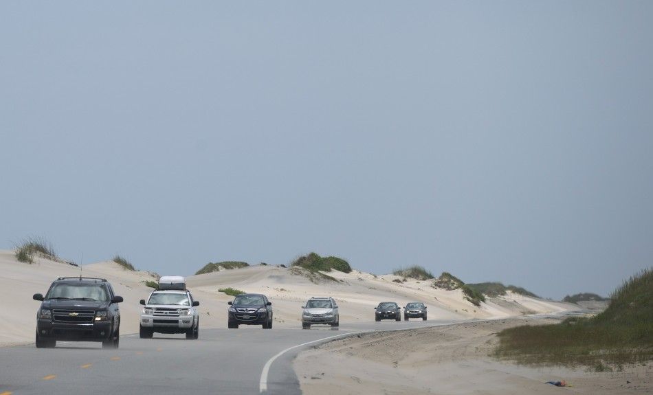 REFILE - CORRECTING GRAMMAR  Vehicles make their way north on Highway 12 during an evacuation ahead of Hurricane Arthur in Pea Island, North Carolina July 3, 2014. The first hurricane of the Atlantic season gained strength on Thursday and is expected to a