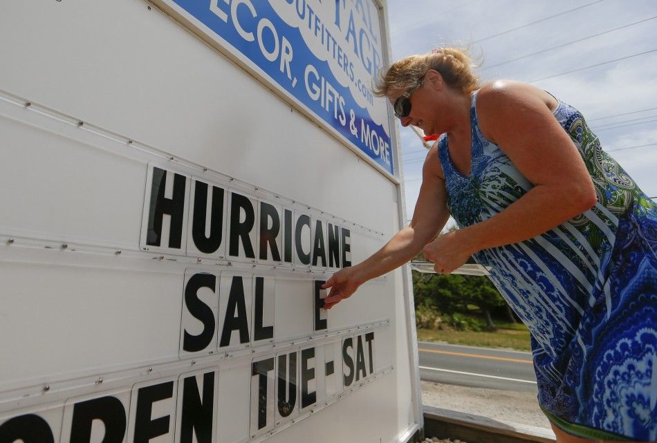 Maryline Epping of Avon, North Carolina finishes the words on a sign out in front of her shop before Hurricane Arthur in Buxton, North Carolina July 3, 2014. The first hurricane of the Atlantic season gained strength on Thursday and is expected to attain 