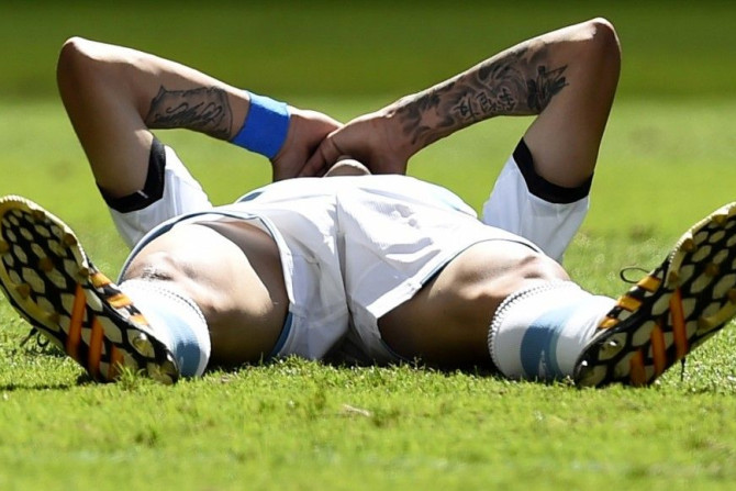 Argentina&#039;s Angel Di Maria lies on the pitch after an injury during the team&#039;s 2014 World Cup quarter-finals against Belgium at the Brasilia national stadium in Brasilia July 5, 2014.