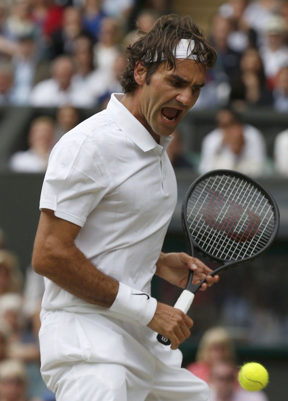 Roger Federer of Switzerland reacts during his mens singles final tennis match against Novak Djokovic of Serbia at the Wimbledon Tennis Championships, in London July 6, 2014. 