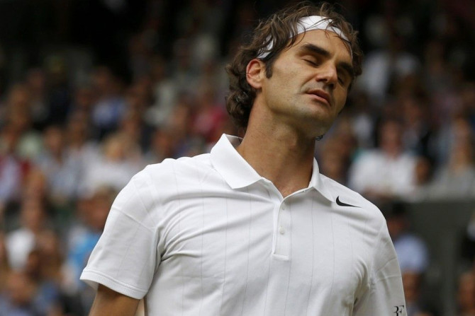Roger Federer of Switzerland reacts during his men's singles final tennis match against Novak Djokovic of Serbia at the Wimbledon Tennis Championships, in London July 6, 2014. 