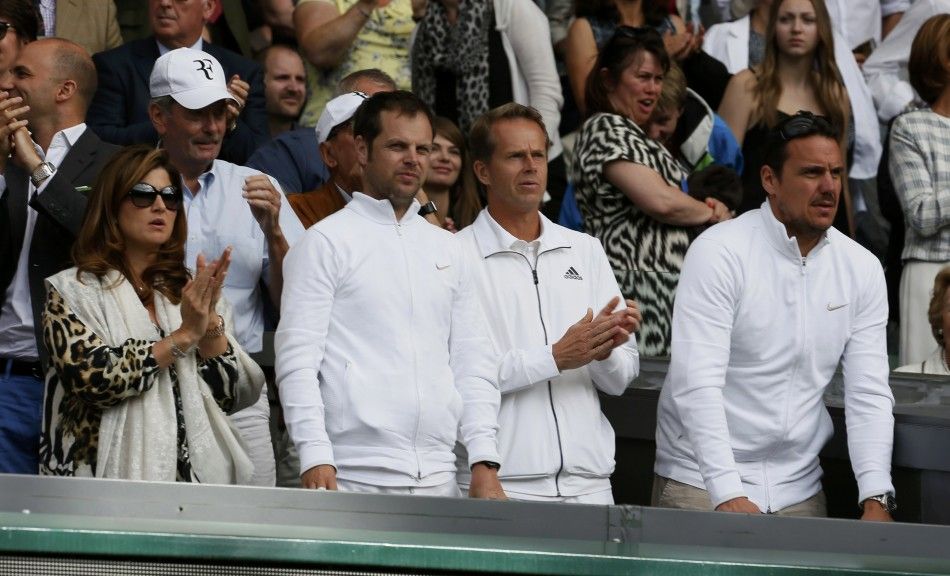 The team of Roger Federer of Switzerland, including his wife Mirka Federer L and coach Stefan Edberg 2nd R applaud during his mens singles final tennis match against Novak Djokovic of Serbia at the Wimbledon Tennis Championships, in London July 6, 20