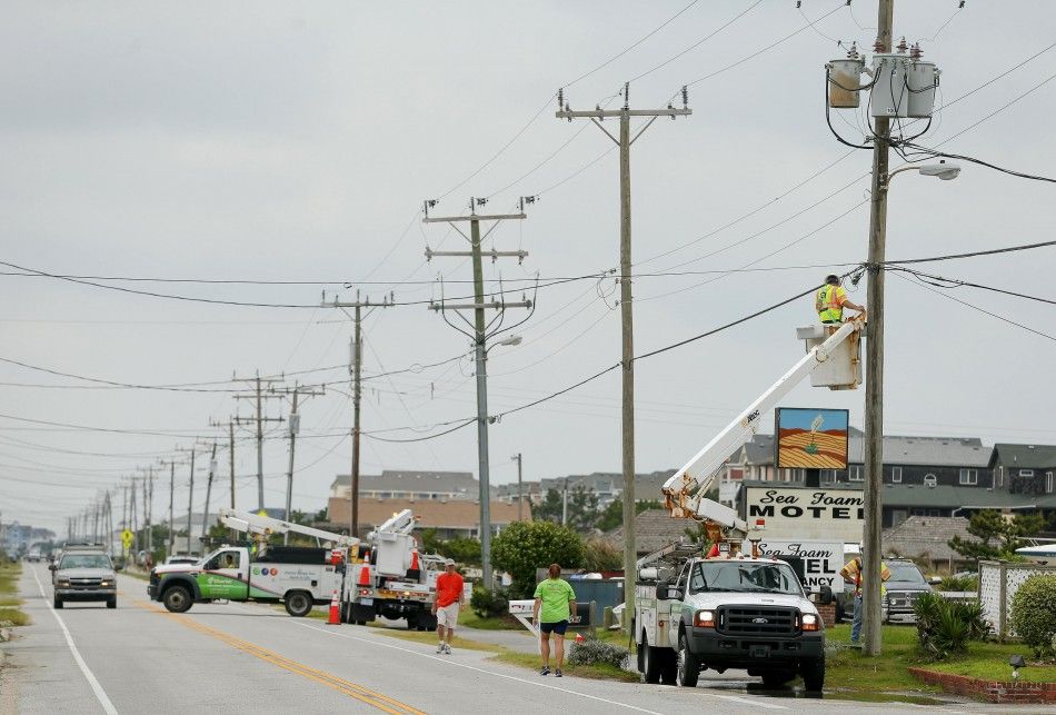 A worker from the local cable company works on the utility lines after Hurricane Arthur in Nags Head, North Carolina July 4, 2014.  REUTERSChris Keane