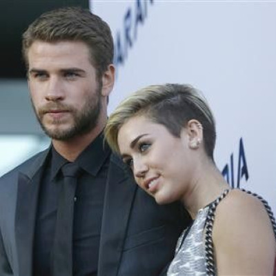 Liam Hemsworth and Miley Cyrus with his fiancee, singer Miley Cyrus, at the premiere of ''Paranoia'' in Los Angeles, California