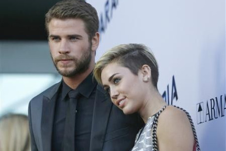 Liam Hemsworth and Miley Cyrus with his fiancee, singer Miley Cyrus, at the premiere of ''Paranoia'' in Los Angeles, California