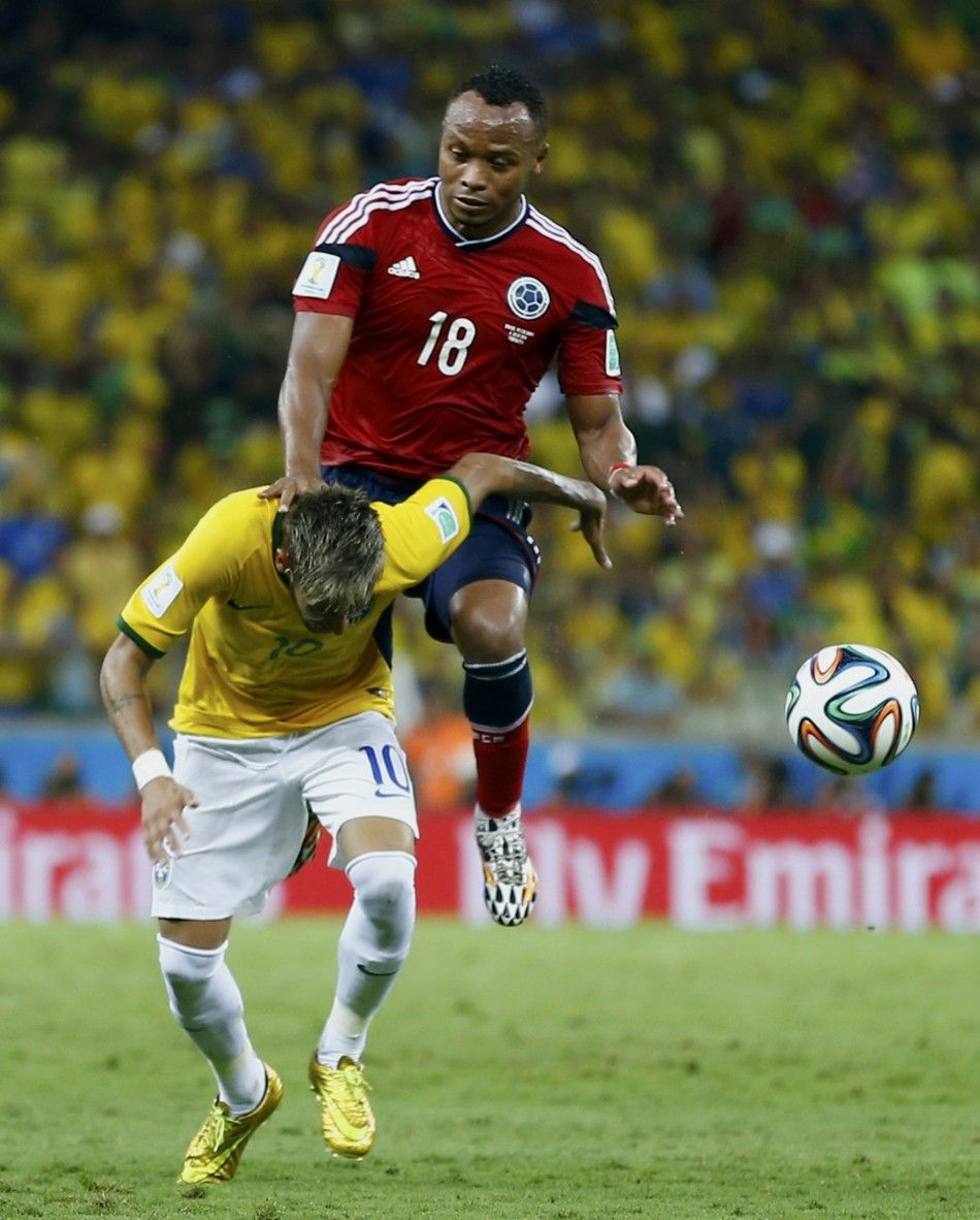Brazils Neymar bottom is fouled by Colombias Camilo Zuniga 