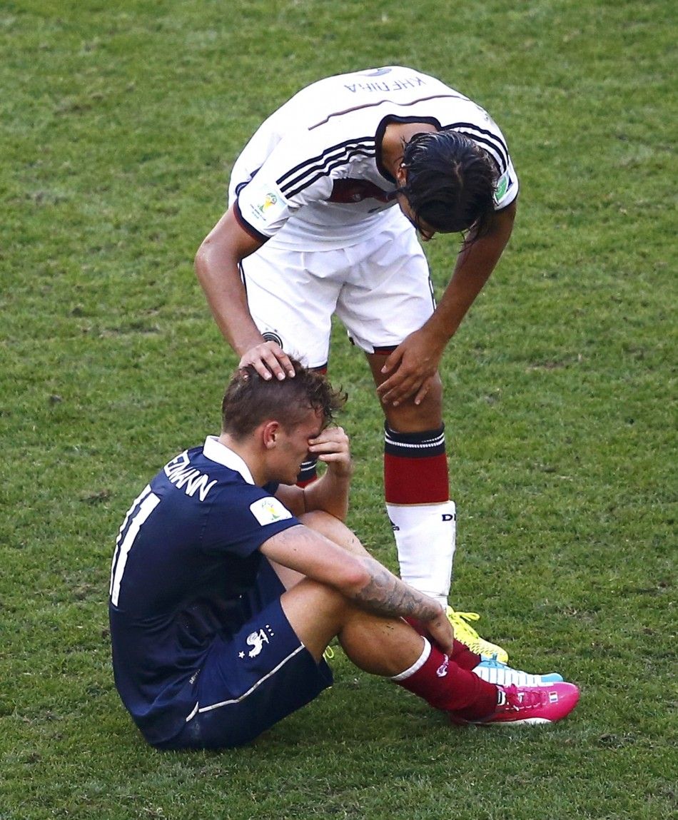 Germanys Sami Khedira comforts Frances Antoine Griezmann