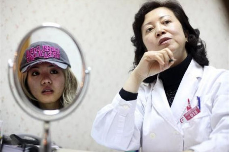 Xiaoqing (L) and a consultant take part in an interview with Reuters at the Time Plastic surgery clinic in Shanghai February 4, 2010. The 21-year-old, who would only give her name as Xiaoqing, is seeking extensive plastic surgery to look like U.S. actress