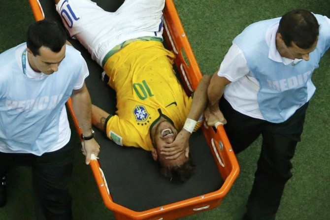 Brazil's Neymar grimaces as he is carried off the pitch after being injured during their 2014 World Cup quarter-finals against Colombia at the Castelao arena in Fortaleza July 4, 2014.