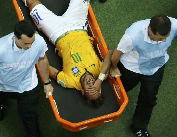 Brazil's Neymar grimaces as he is carried off the pitch after being injured during their 2014 World Cup quarter-finals against Colombia at the Castelao arena in Fortaleza July 4, 2014.